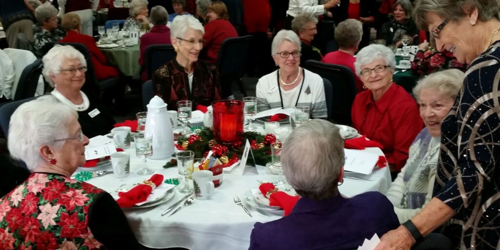 A group of older women sitting at a table.